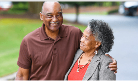 Two people hugging and smiling