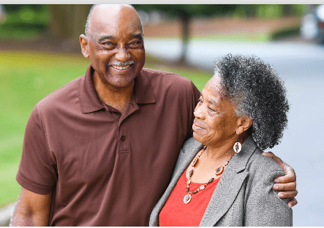 Two people hugging and smiling