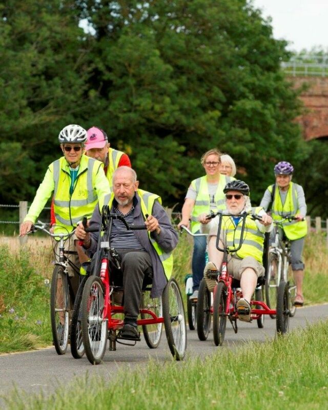 Group of cyclists riding adapted bicycles