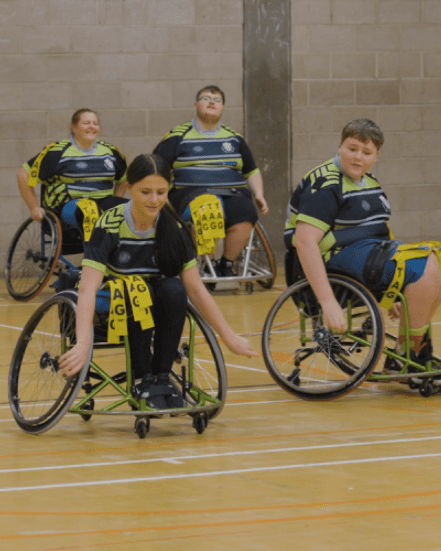 two people playing wheelchair rugby