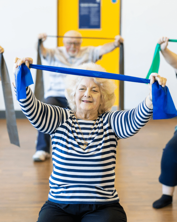 people with their arms up holding a resistance band